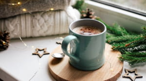 cup of hot chocolate on windowsill in winter